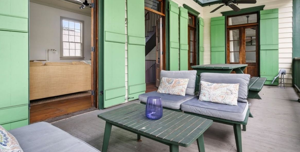 Furnished outdoor porch at a Charleston-style vacation rental